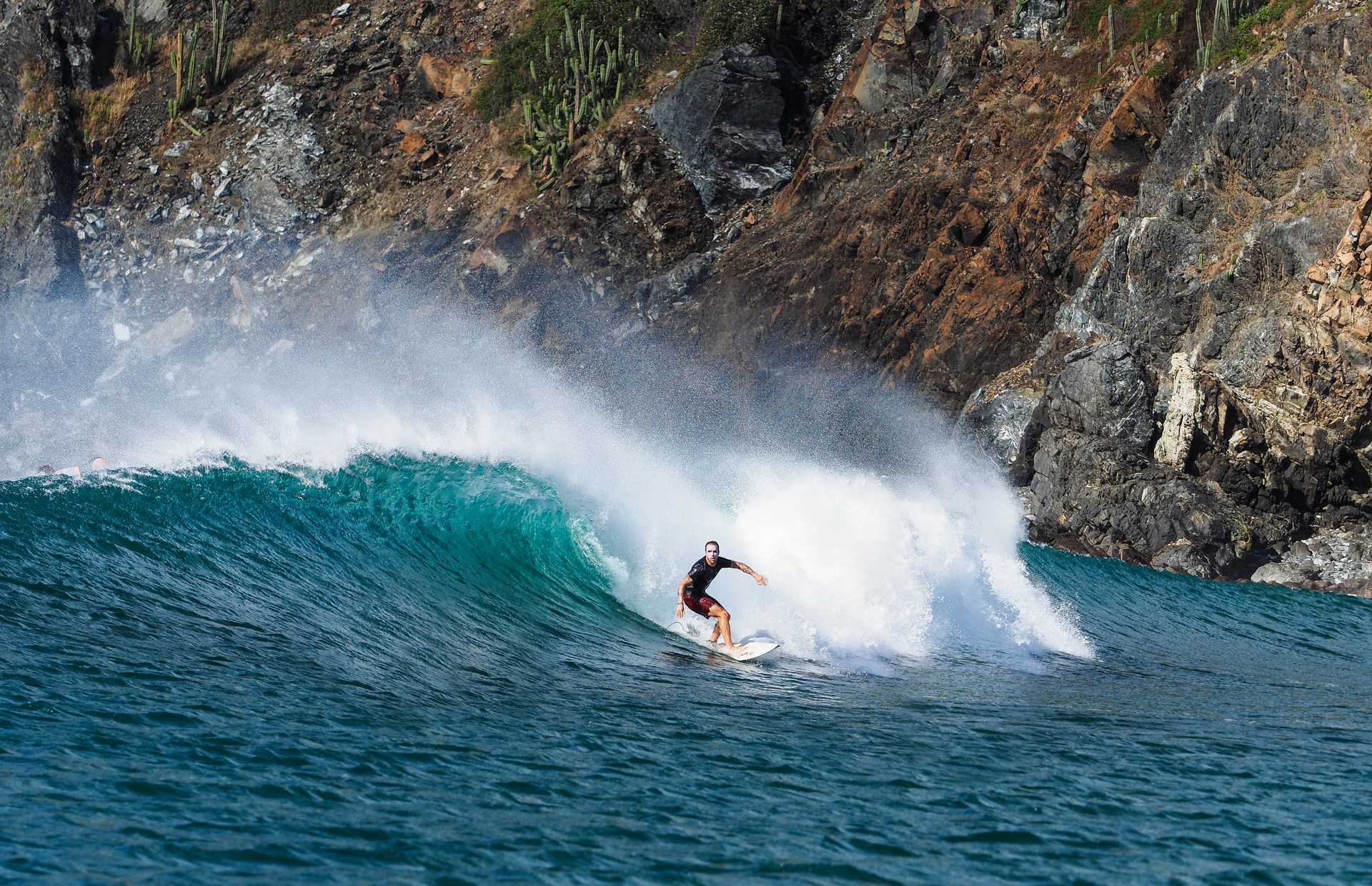 A man surfing a huge wave