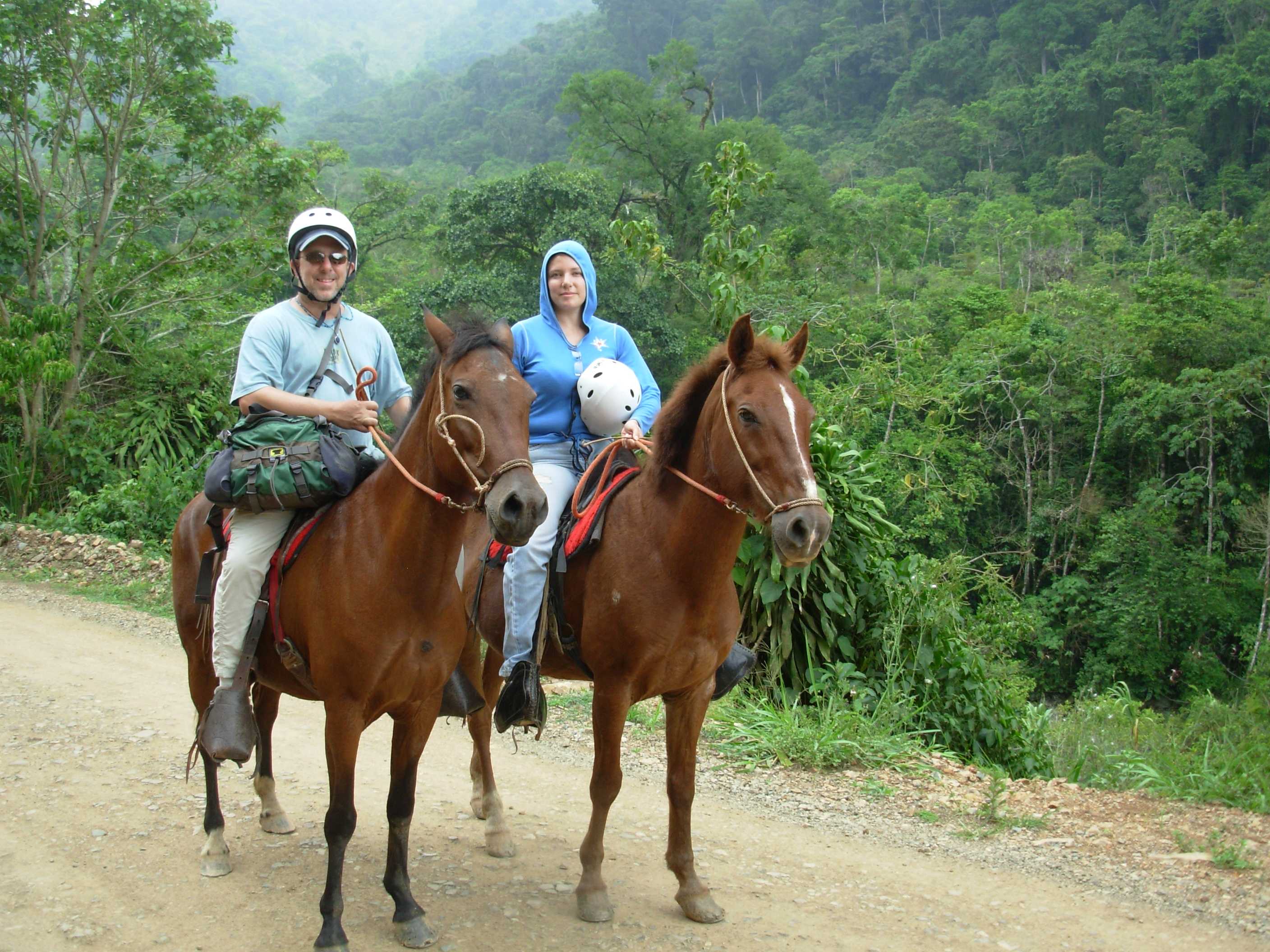 A couple horseriding in the forest