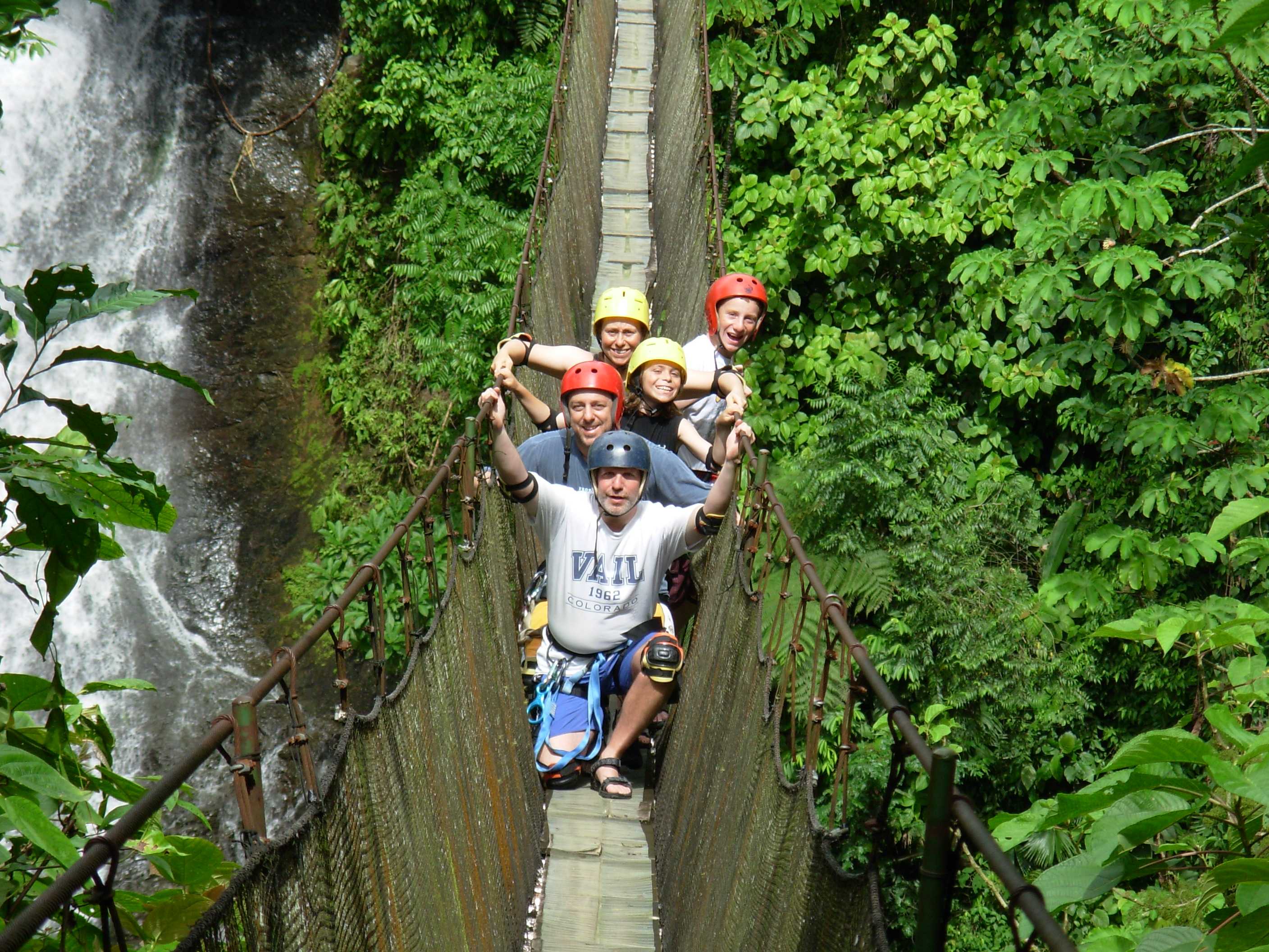 A family standing on a hanging bridge